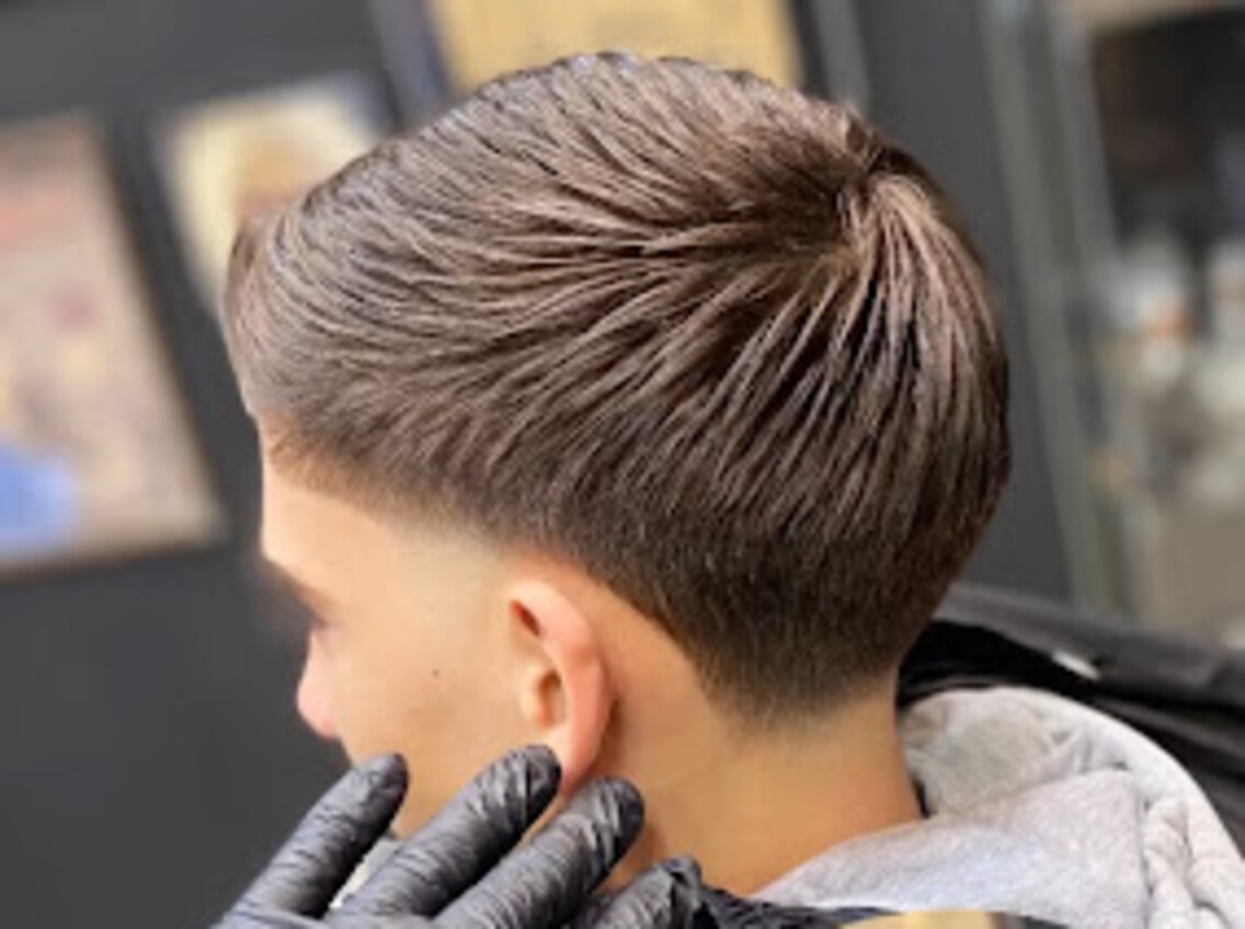 Freshly cut taper fade with textured top, styled at Barbaros Barbershop